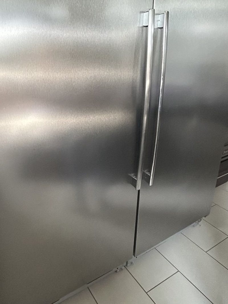 Freezer side of a built-in Frigidaire pair where the ice maker lives, doors closed