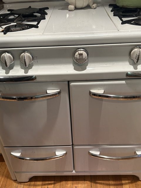 Vintage white gas range with four burners and chrome handles in a downtown Nampa kitchen